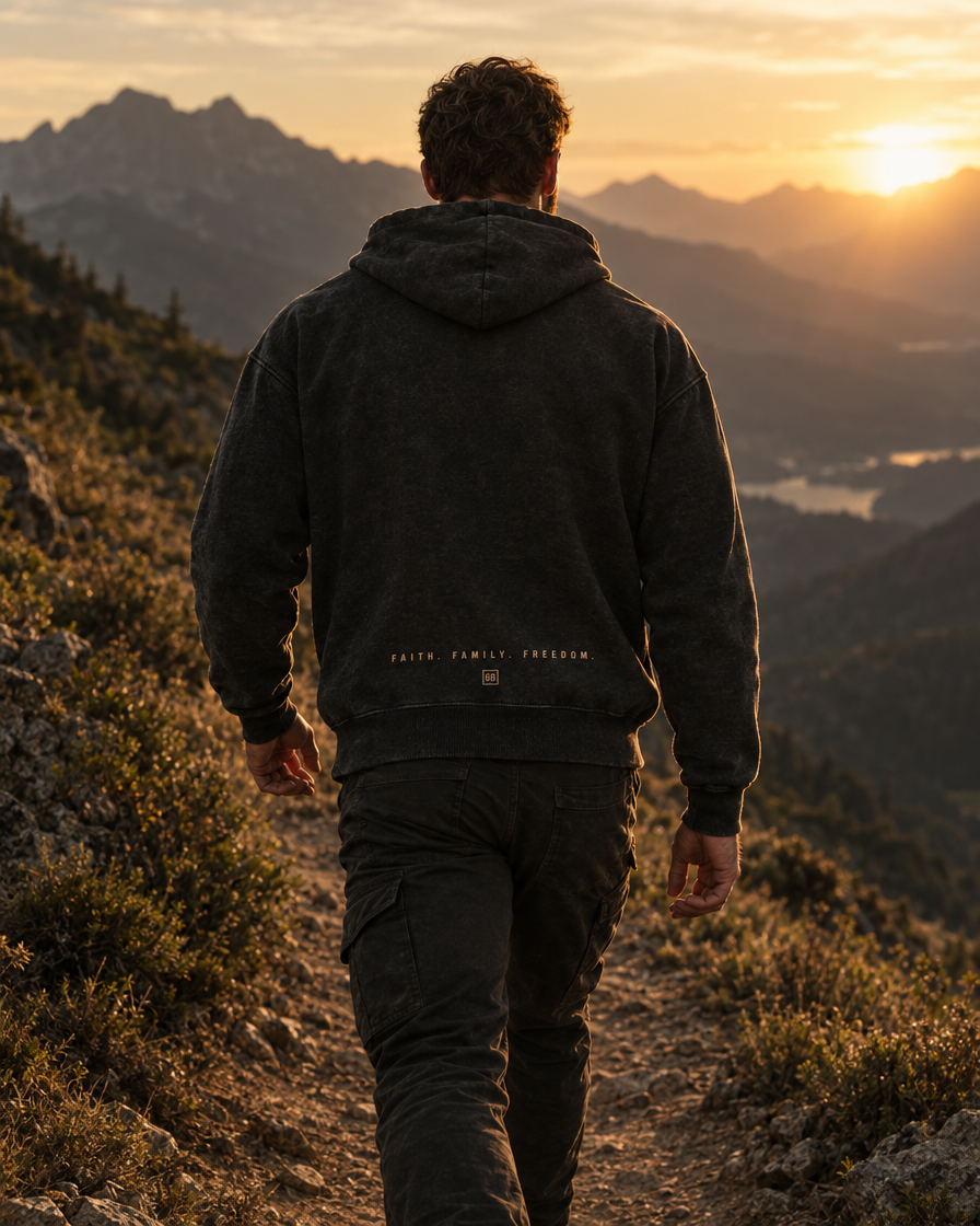 The Glory Be Hoodie worn on a mountain trail, back view